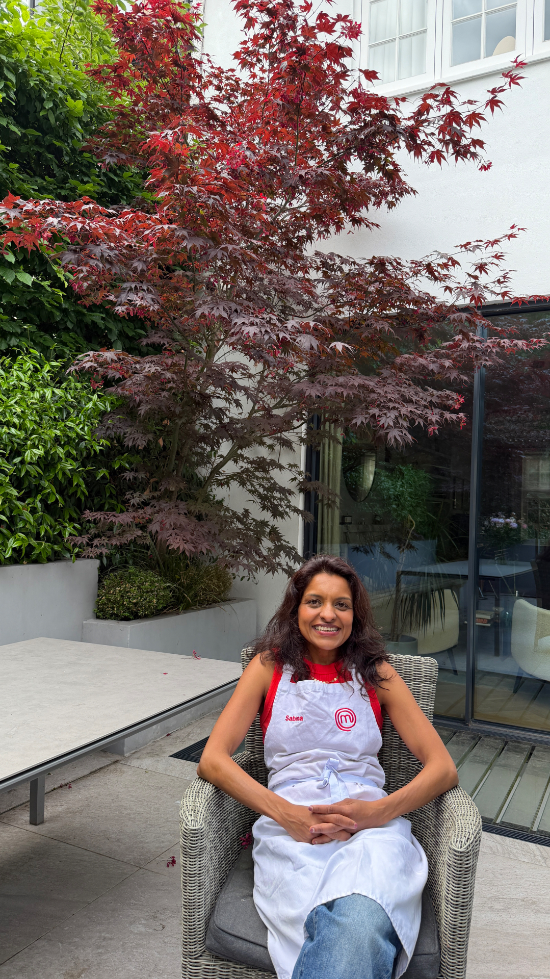 Sabina in her MasterChef apron in the garden