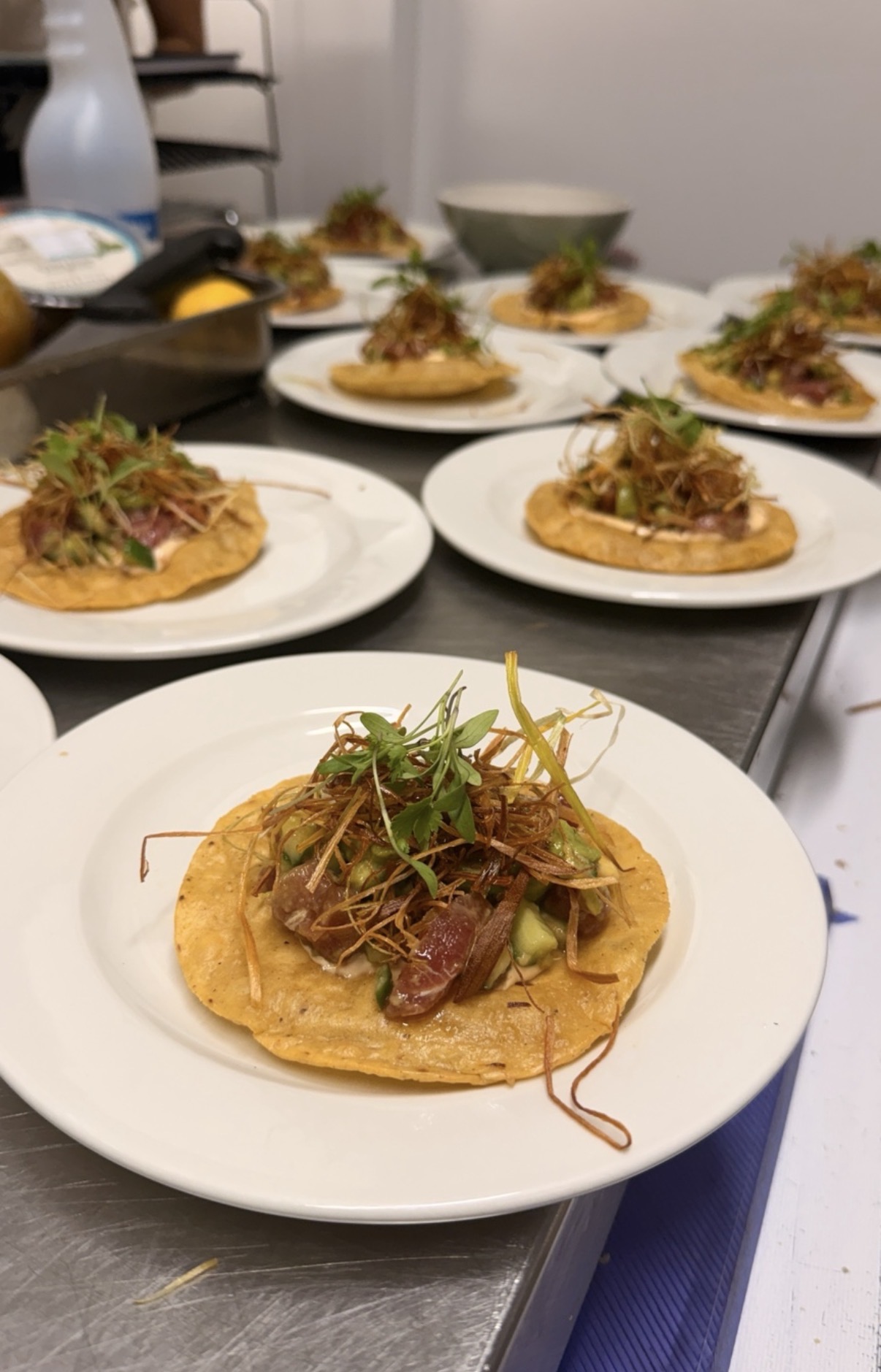 Mexican-inspired yellowtail hamachi on crisp golden tortillas, plated for supper-club guests