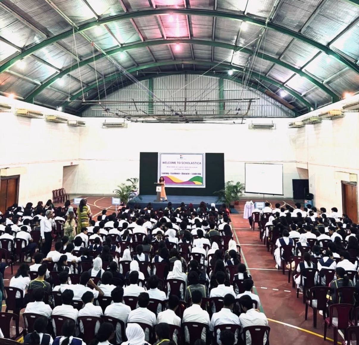 Sabina speaking to an audience of students at Scholastica