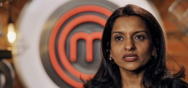 Sabina on MasterChef UK with the MasterChef emblem behind her