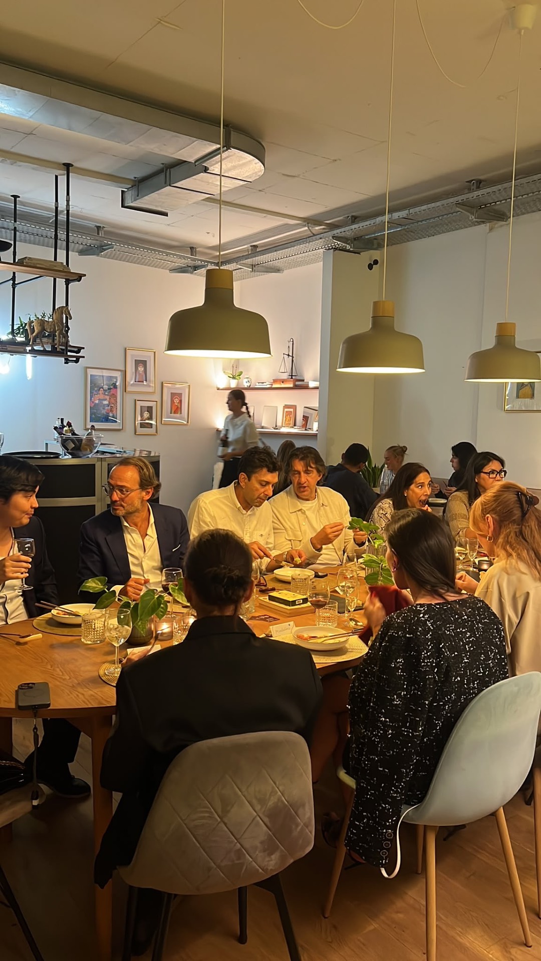 Guests sharing dinner around a long table