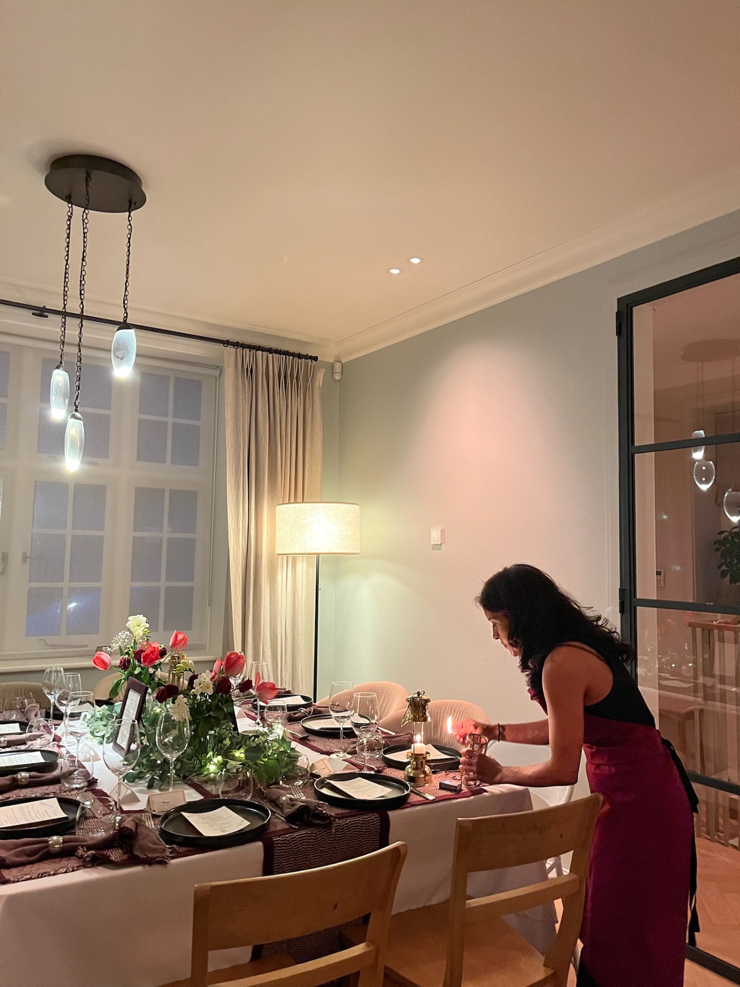 Sabina preparing an intimate candlelit dining table